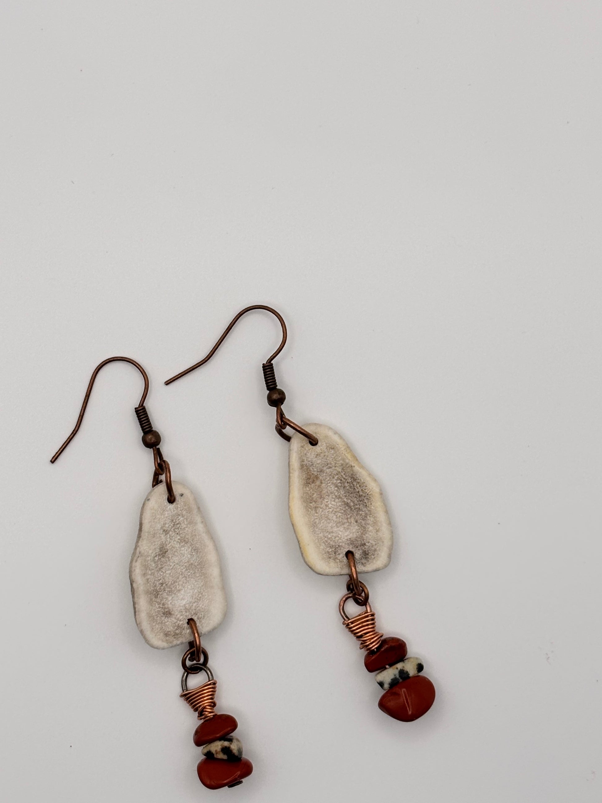 Natural antler and jasper earrings flat lay 