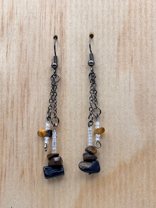 Two beaded chains with stones on a wooden surface
