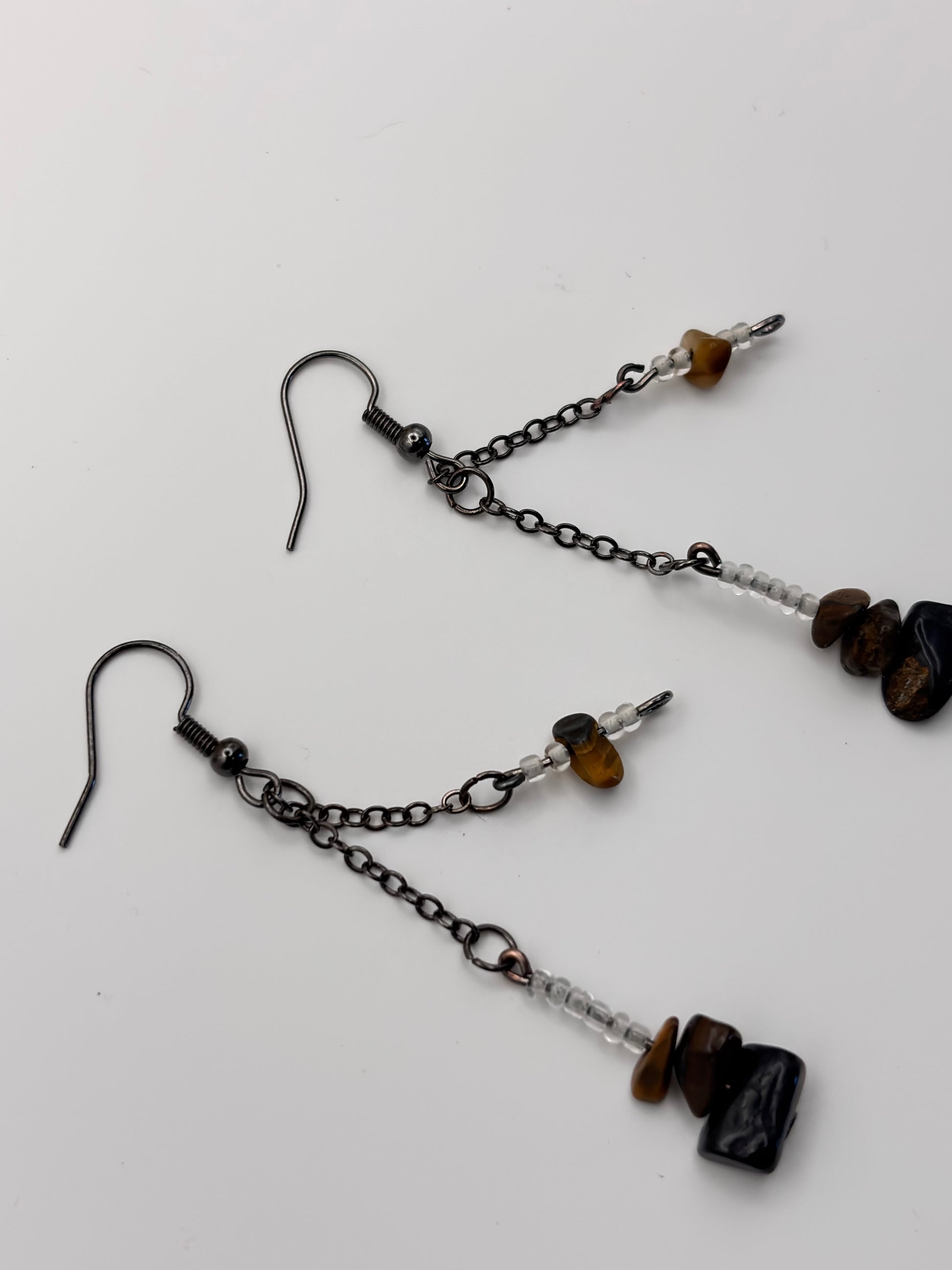 Pair of black beaded earrings on a white background