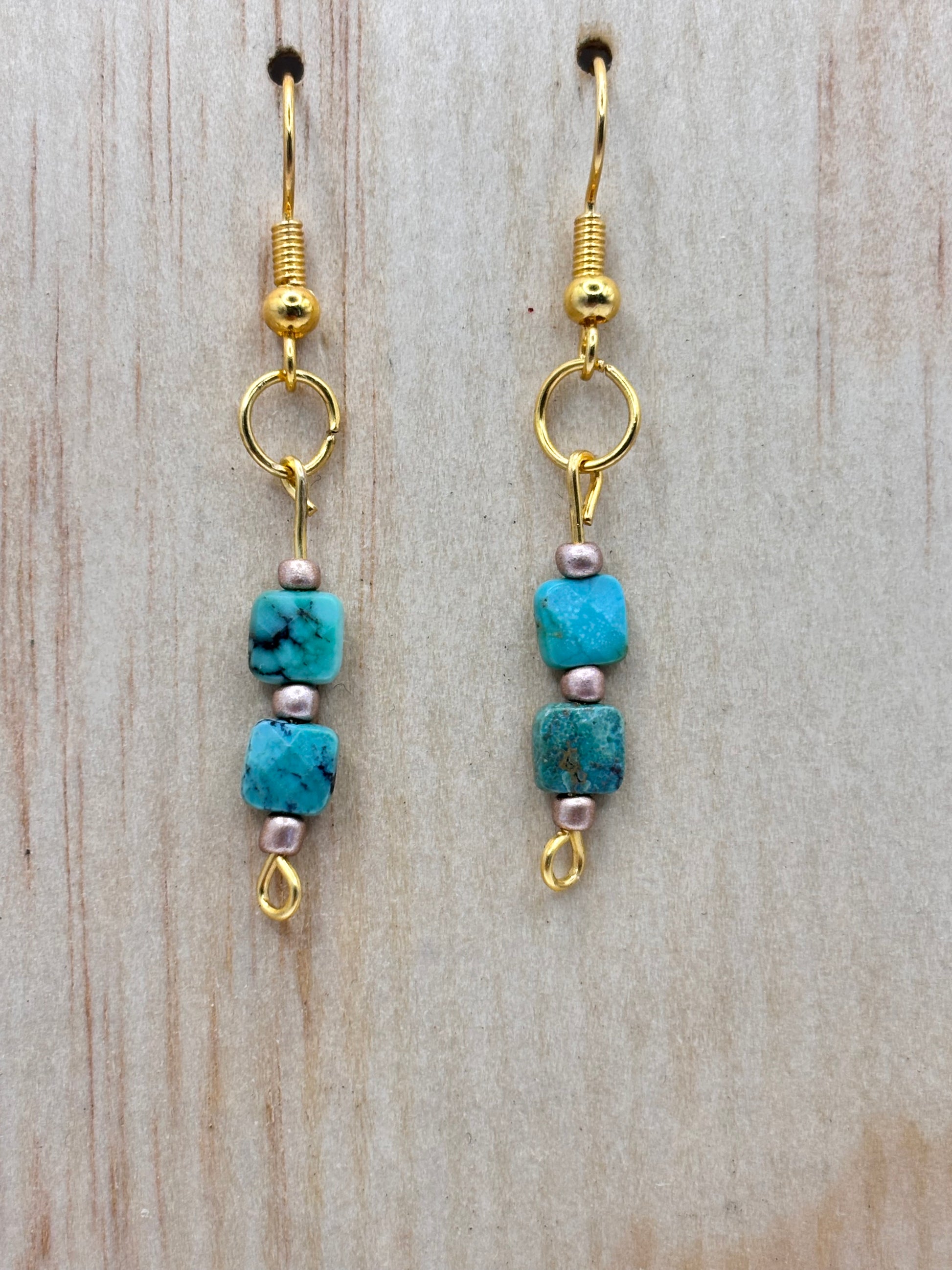 Handmade turquoise stone drop earrings with warm gold accents